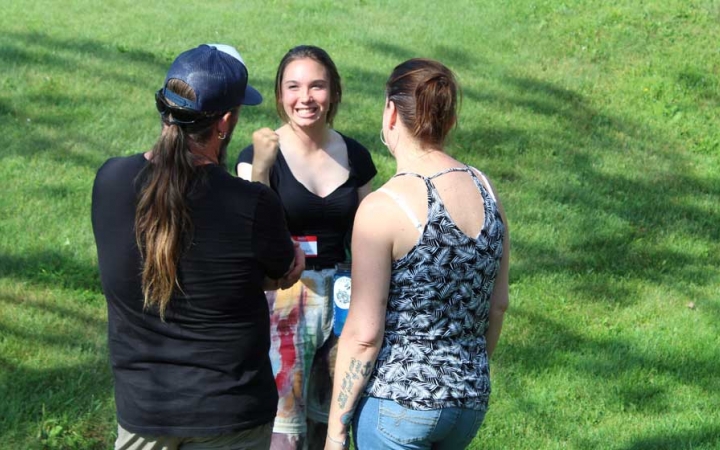 Three people speak to each other at the family seminar of an outward bound intercept course